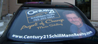 Window perforated digital print graphic for SchillMann Realty. Includes real estate agent photo
